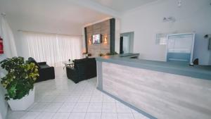 a lobby with a counter in a building at Nacional Park Hotel Lages in Lages
