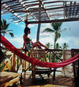 a woman sitting on a hammock on a deck at Private Study Punta Cana in Punta Cana