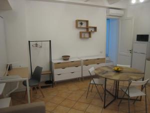 a living room with a table and a dining room at Smart Nest Lipari in Lipari