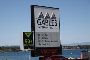 
a sign that is on the side of a body of water at Gables Lakefront Motel in Taupo
