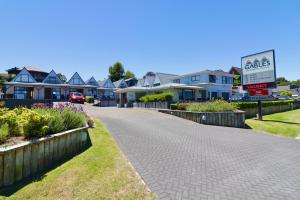 eine Kopfsteinpflasterstraße in einem Wohnviertel mit Häusern in der Unterkunft Gables Lakefront Resort in Taupo