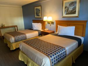 a hotel room with two beds and two lamps at Knights Inn - Lithonia in Lithonia