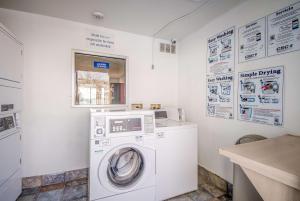 a washer and dryer in a white laundry room at Motel 6-Elko, NV in Elko