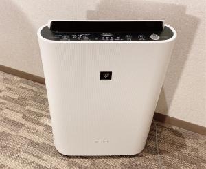 a white cpu sitting on the floor next to a wall at KOKO HOTEL Sapporo Odori in Sapporo