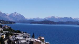 a view of a large body of water with mountains at Studio Center Bariloche in San Carlos de Bariloche