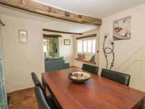 a dining room with a wooden table and chairs at Bumble Bee in Oakham