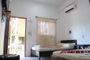 Ένα ή περισσότερα κρεβάτια σε δωμάτιο στο Posada Turística Nory