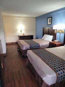 a hotel room with two beds and a telephone at Knights Inn - Lithonia in Lithonia