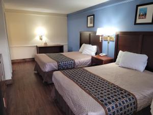 a hotel room with two beds and a phone at Knights Inn - Lithonia in Lithonia