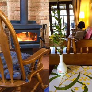 sala de estar con chimenea y mecedora en Clover Cottage Country Retreat, en Manjimup