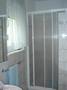 a bathroom with a shower and a sink at Apartments Kate - 20m from the beach in Brist