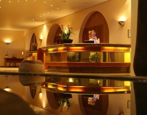 a woman standing in the lobby of a building at Wyndham Garden Donaueschingen in Donaueschingen