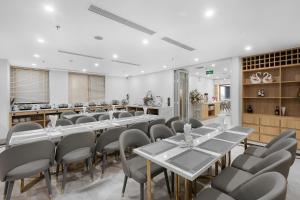 a conference room with tables and chairs in a room at Thai Ha Boutique Hotel in Ha Long
