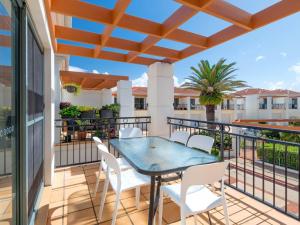 a patio with a table and chairs on a balcony at Beach Break in Yamba