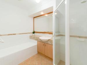 a bathroom with a sink and a tub and a toilet at Beach Break in Yamba