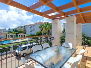 a patio with a table and chairs on a balcony at Beach Break in Yamba