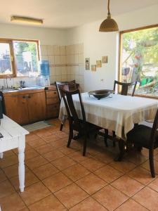 a kitchen with a table and chairs and a kitchen with a counter at Alto Curanipe in Pelluhue