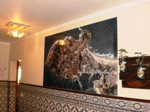 a large screen on the wall of a building at SwordFish Eco-House Peniche in Peniche