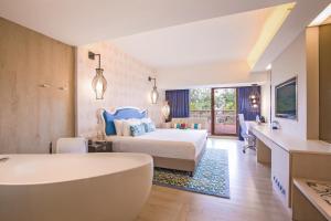 a hotel room with a bed and a bath tub at Village Hotel Katong by Far East Hospitality in Singapore +45 photos