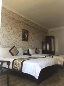 Cama ou camas em um quarto em Tai Loc Hotel