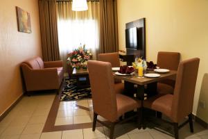 a room with a dining room table and chairs at Spark Residence Hotel in Sharjah