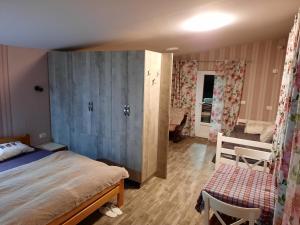 a bedroom with a bed and a table in a room at Green Villa Rodna in Skopje