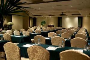 a room full of tables and chairs with tables and chairs at Grand Forward Hotel in Taipei