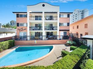 an apartment with a swimming pool in front of a building at Peurto Vallerta Unit 2 in Gold Coast