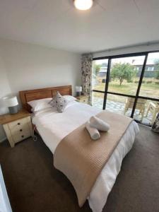 a bedroom with a large bed and a large window at Mountain Views, Nice Spot Newly renovated in Lake Tekapo