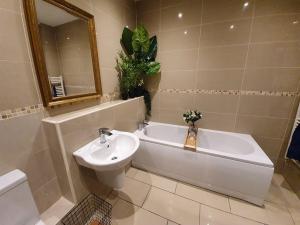 a bathroom with a sink and a tub and a toilet at Enchanted Hideaway, Bath in Bath