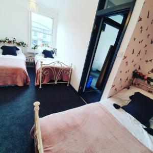 a bedroom with two beds and a large mirror at Enchanted Hideaway, Bath in Bath