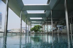 an empty building with a tree in the middle of the water at Morrissey Hotel Residences in Jakarta