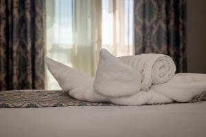 a pile of towels sitting on top of a bed at Point de vue Guesthouse in Rabat