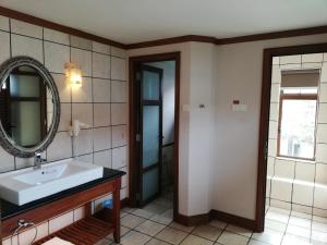 un bagno con lavandino e specchio di Wonderland Private Pool Villas at Port Dickson a Port Dickson