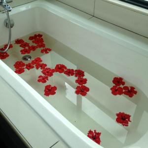 a white bath tub with red flowers in it at KM1 West Kuala Lumpur, Malaysia in Kuala Lumpur