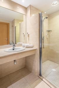 
a bathroom with a shower, sink, and mirror at B&B Hotel Madrid Arganda in Arganda del Rey

