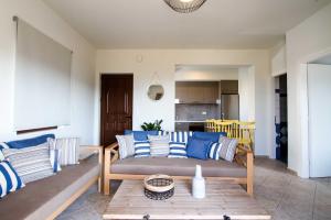 a living room with blue and white pillows on a couch at Mike's apartment I Luxury above the sea in Kissamos