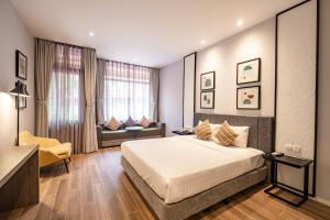 a hotel room with a bed and a couch at Seava Ho Tram Beach Resort in Ho Coc