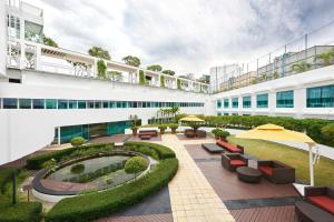 an external view of a building with a courtyard at Village Hotel Changi by Far East Hospitality in Singapore