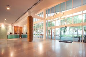 a large building with a lobby with large windows at Village Hotel Changi by Far East Hospitality in Singapore