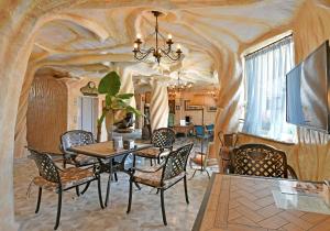 a dining room with a table and chairs at Sirena Palace Family Hotel in Obzor