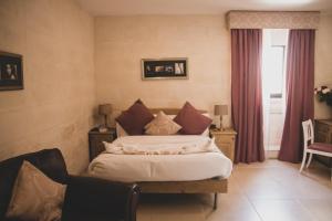 Una cama o camas en una habitación de Point de vue Guesthouse