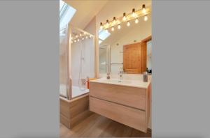 a bathroom with a sink and a mirror at Ferienwohnung Gelting in Geretsried +18 photos