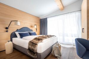 Posteľ alebo postele v izbe v ubytovaní Sporthotel Chalet