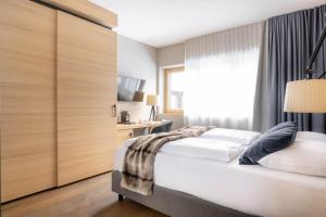 Posteľ alebo postele v izbe v ubytovaní Sporthotel Chalet