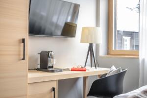 Televízia a/alebo spoločenská miestnosť v ubytovaní Sporthotel Chalet