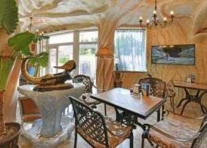 a living room with a table and chairs at Sirena Palace Family Hotel in Obzor
