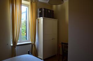 a bedroom with a cabinet with a microwave on top of it at La Buccetta B&B in Verona
