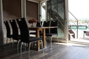 a dining room with a table and chairs and a window at Floating house BRAVIA in Portorož