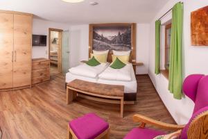 a hotel room with a bed and a couch at Ferienwohnungen Mayer inkl. Chiemgaukarte in Ruhpolding